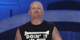 WWE wrestler Jesse James walking out of the entrance ramp during a WWE event with a cut off Road Dogg t-shirt on.