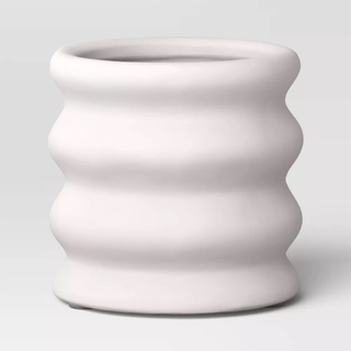 A white ribbed geometric planter pot