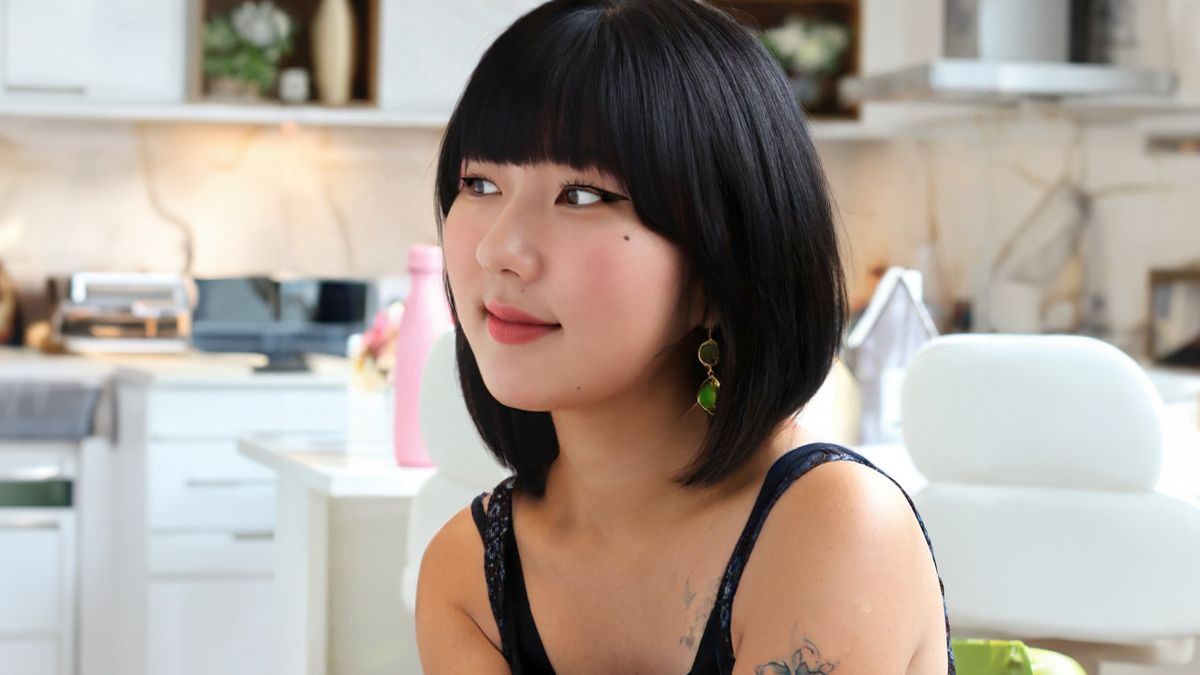 Model with bob cut hair looks off to the side of the frame