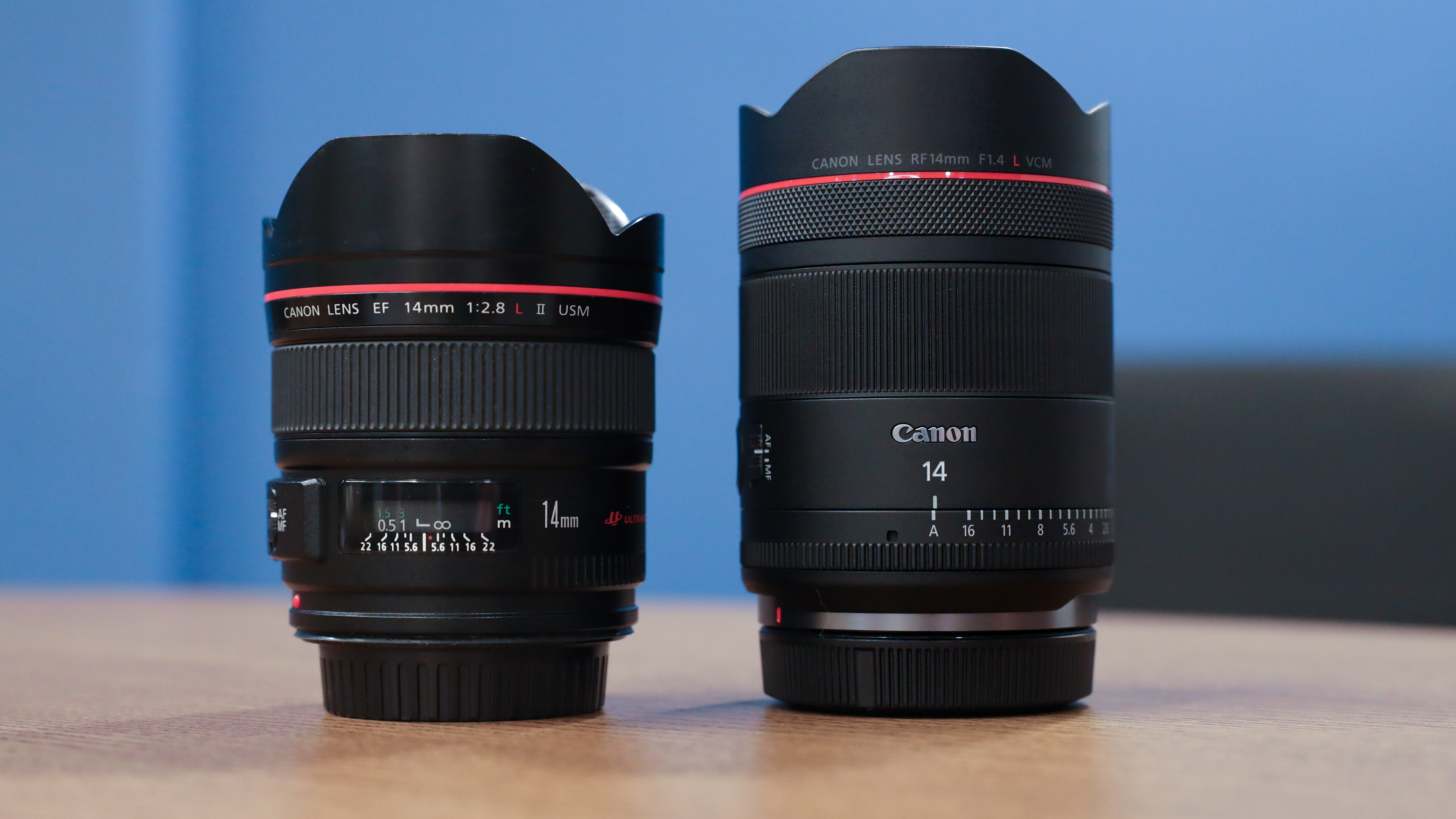 Canon RF 14mm f/1.4L VCM lens next to a Canon EF 14mm f/2.8L USM lens