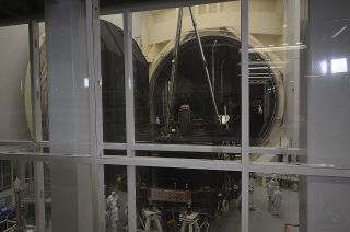 The James Webb Space Telescope's optical instrument section is seen through a window looking into the clean room that surrounds Chamber A at Johnson Space Center in Houston.