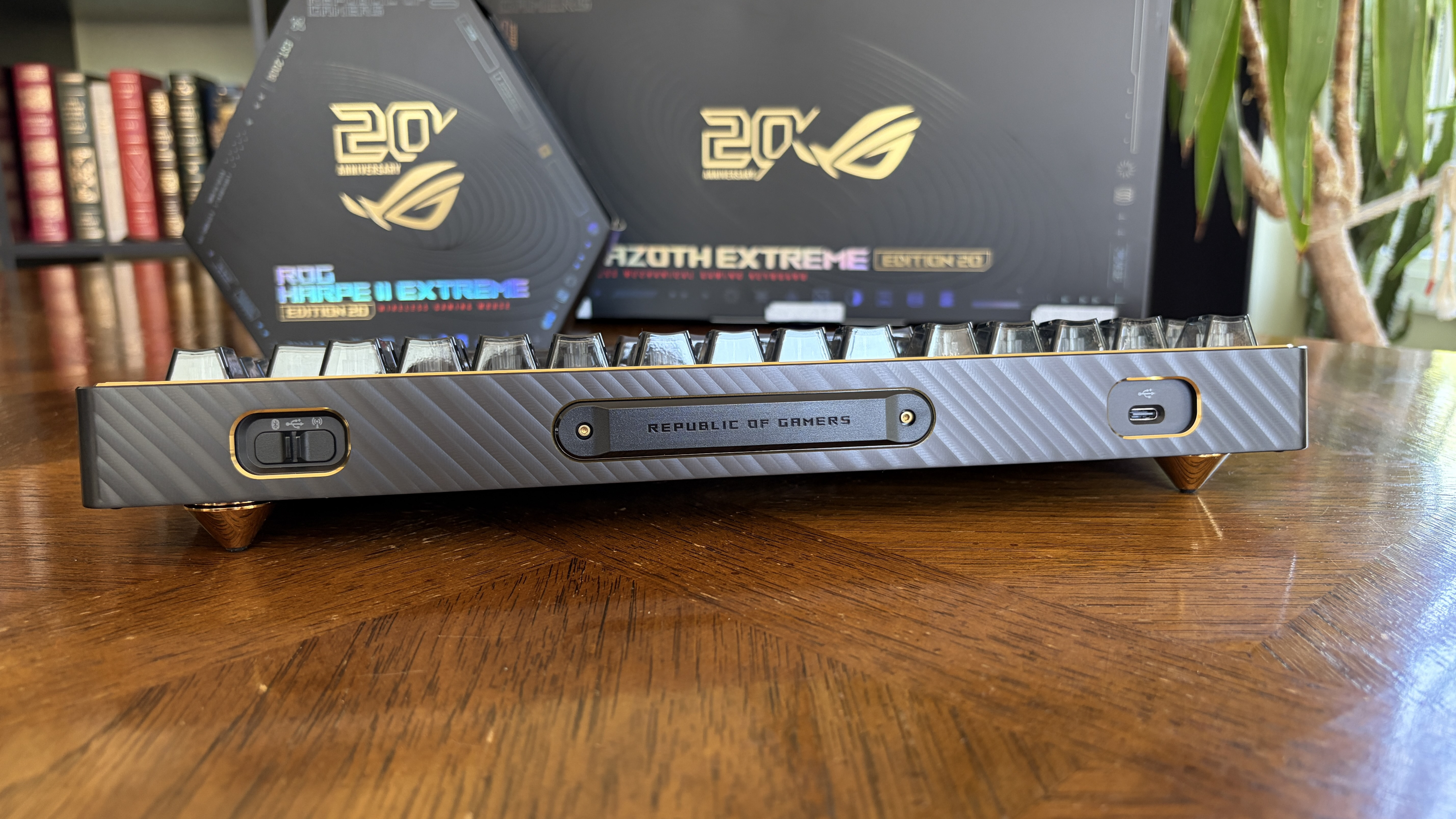 A Republic of Gamers mechanical keyboard with a metal faceplate and a 20th Anniversary box in the background.