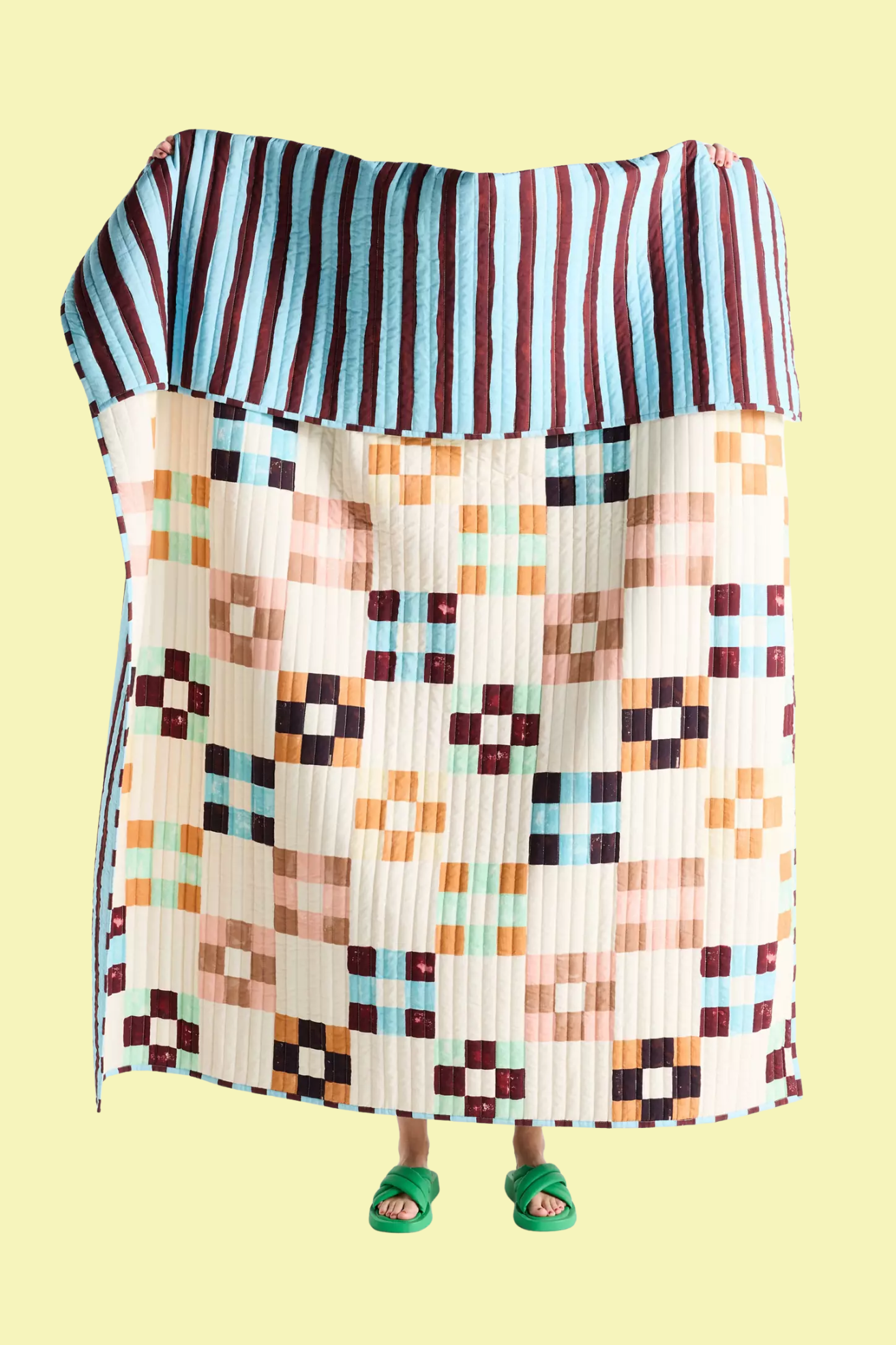 A striped throw blanket with squared patterns