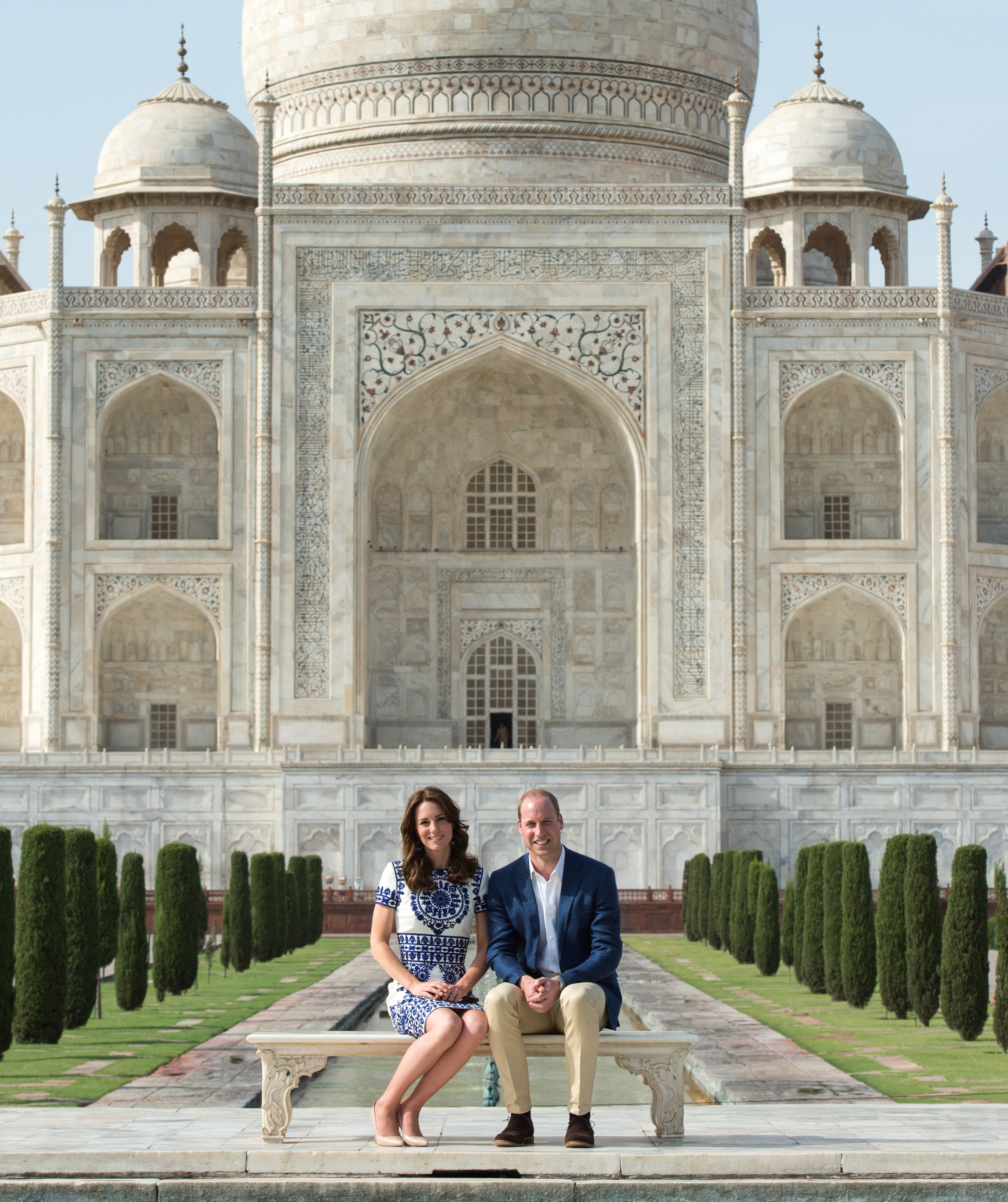 Prince William and Princess Kate sitting in front of the Taj Mahal