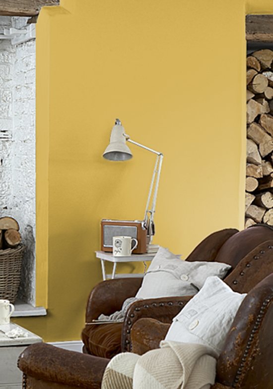An emulsioned living room wall with a brown sofa and chair