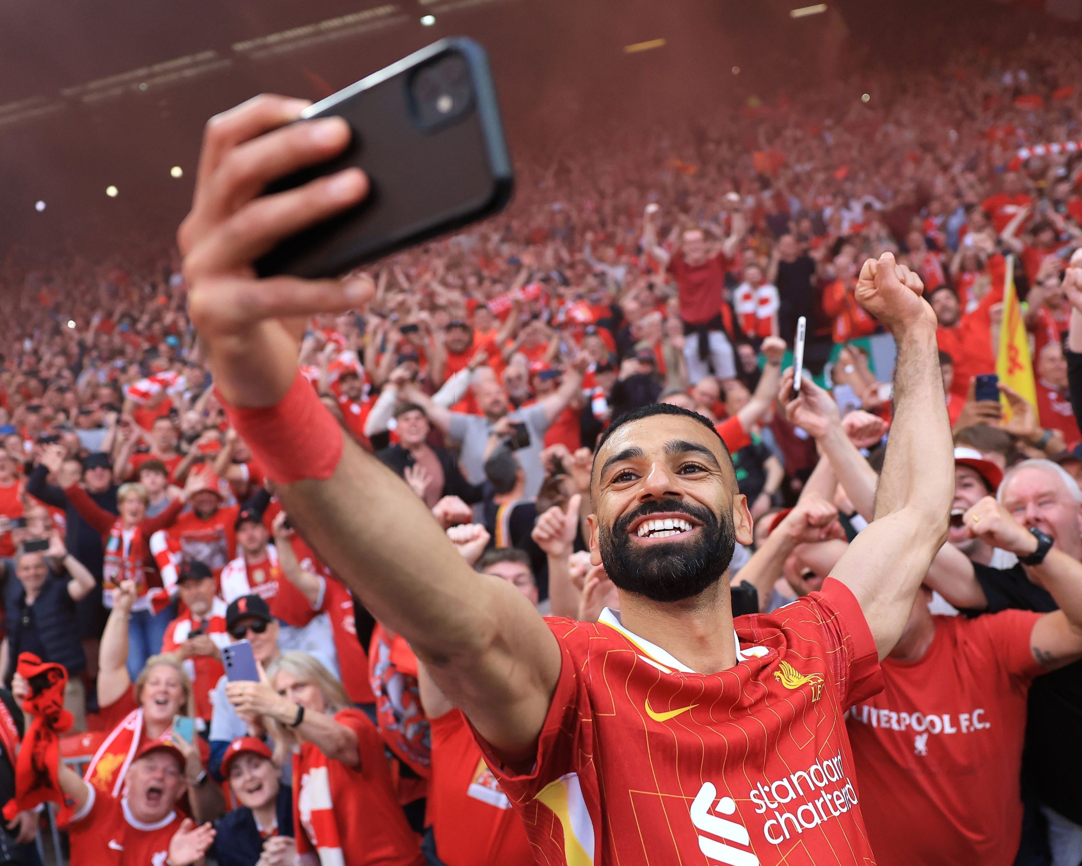 LIVERPOOL, ENGLAND Mo Salah snaps a selfie in front of the Kop following Liverpool’s 5-1 win against Tottenham in late April – a result which confirmed a 20th English title for the Reds. Not pictured: the single tear rolling down Trent Alexander-Arnold’s cheek as he watches on, forlornly.