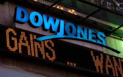 New York, USA - July 29, 2016: The illuminated Dow Jones sign in times square late in the night as the latest news streams on the led board.