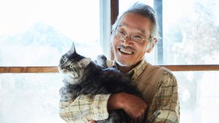 Japanese man holding his cat 