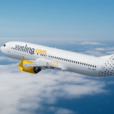 A Vueling plane flying through the sky
