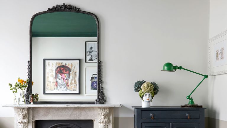 a mantel with an ornate mirror on 