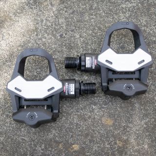 Pair of Leo Keo 2 Max Carbon clipless pedals on the ground 