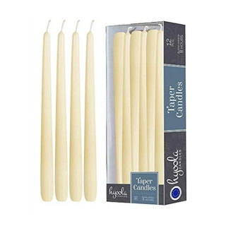 box of taper candles and four outside of the box