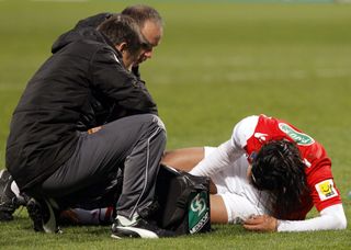 Radamel Falcao receives treatment after suffering a serious knee injury in action for Monaco against Chasselay in January 2014.