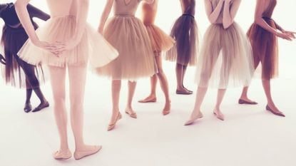 Female ballet dancers with outfits that match their varied skin tones.