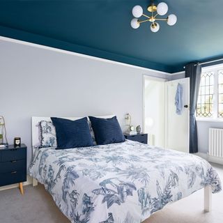 grey bedroom with dark blue painted ceiling