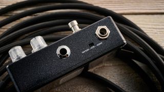 MXR Layers pedal in metallic black finish with clear controls pictured on wood floor with coiled guitar cable