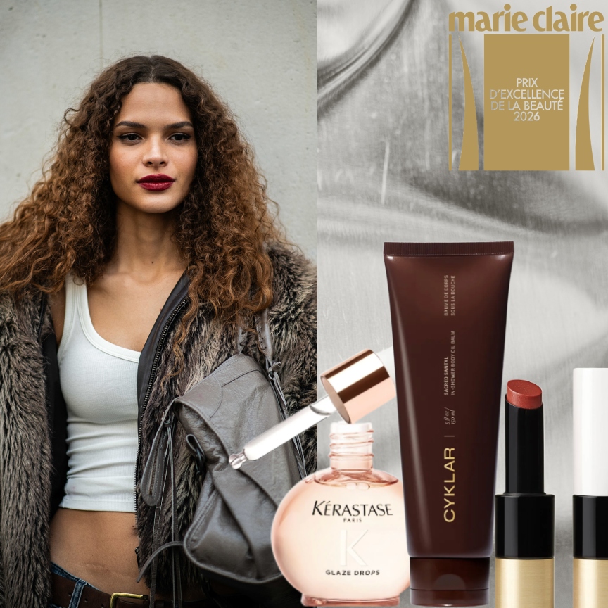 a woman with red lipstick and brown curly hair on a silver background next to beauty product bottles