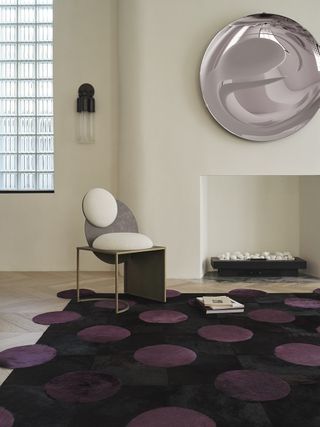 black and purple polka dot rug in neutral living room