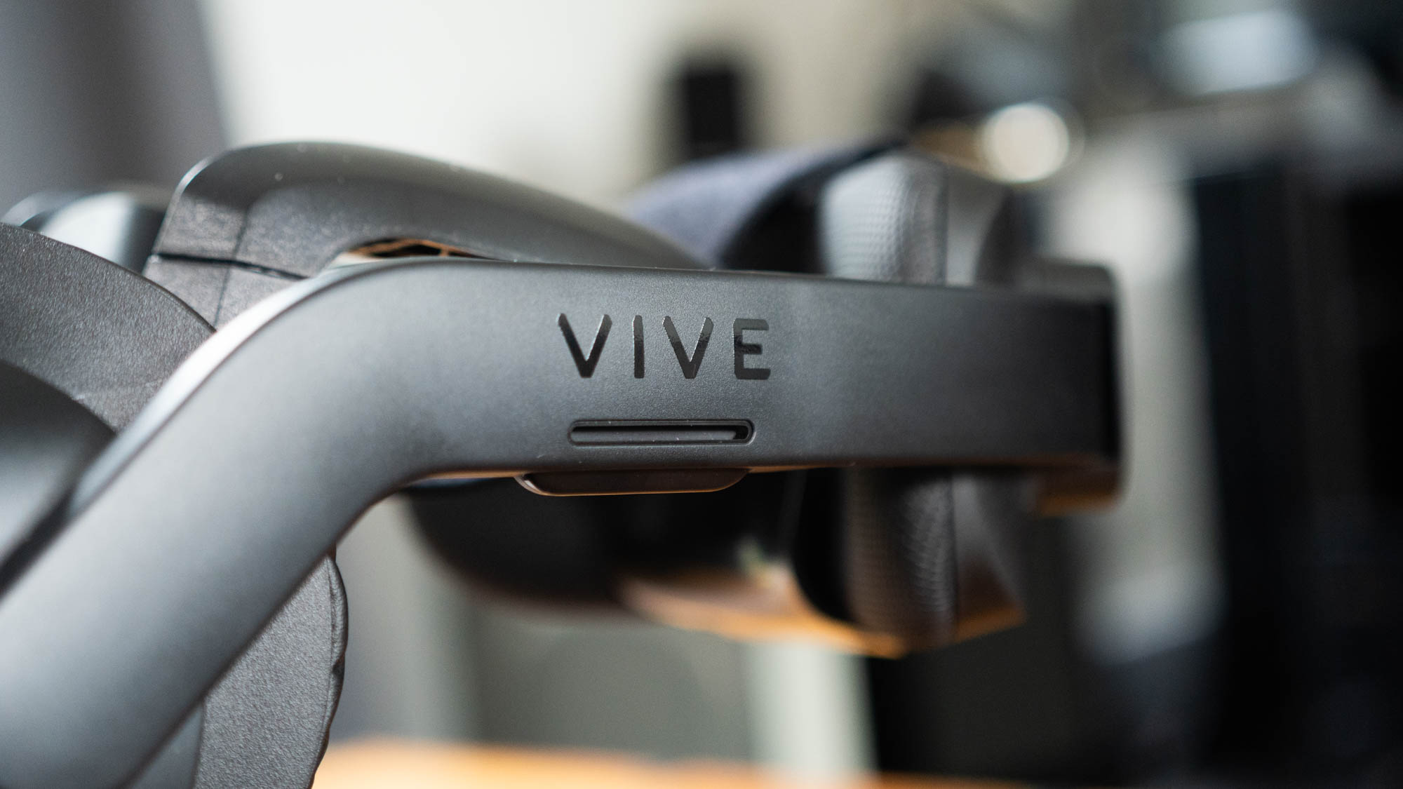 A closeup of the HTC Vive logo as seen on the Vive Focus 3