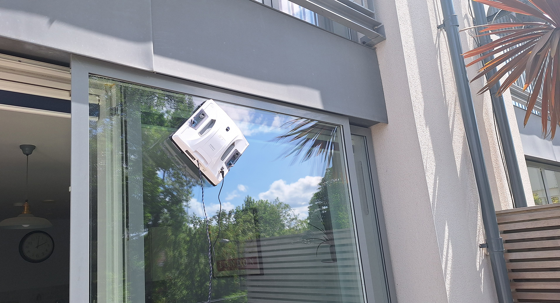Hobot S7 Pro window cleaning robot on outside of reviewer's patio door window