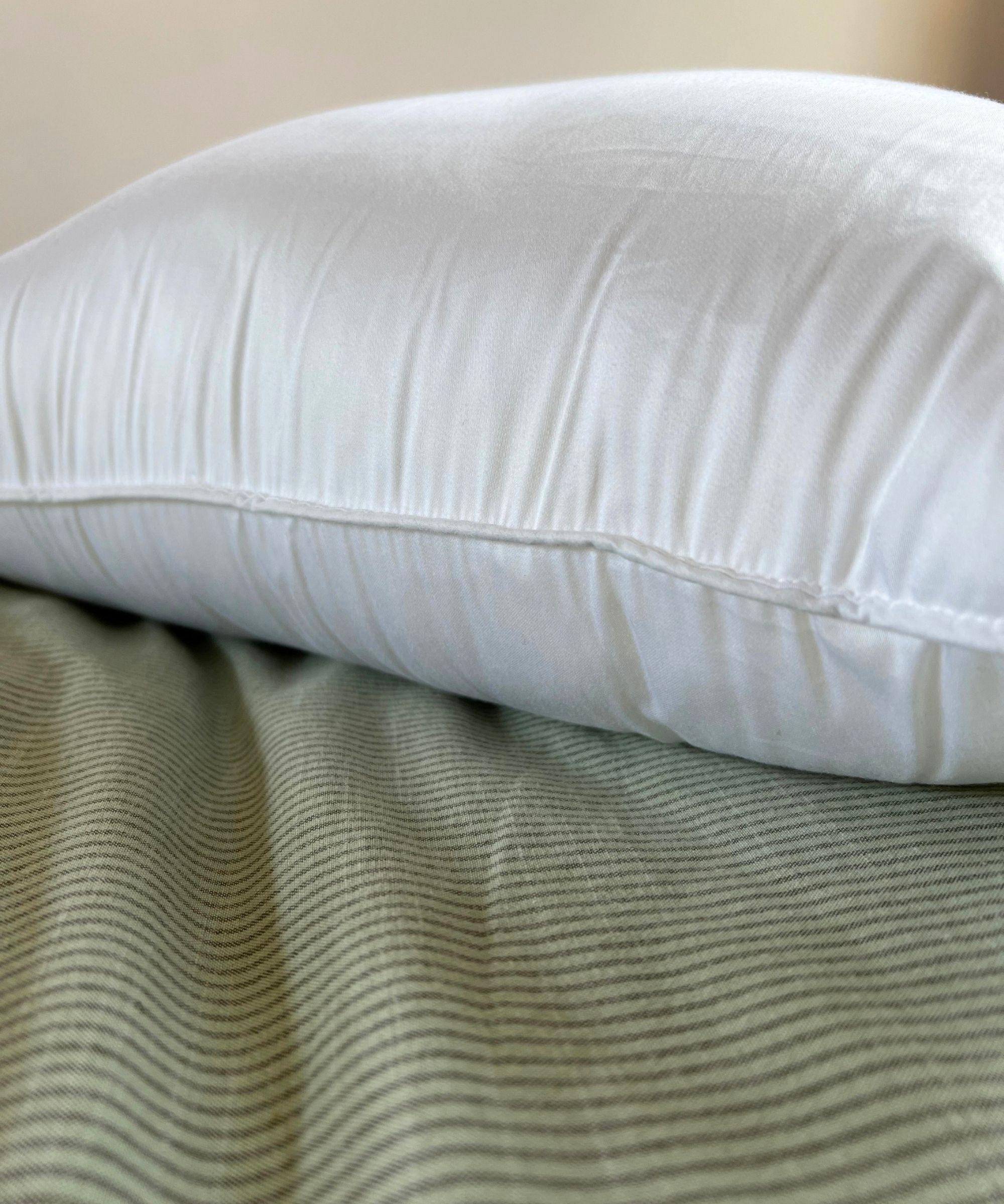 Cozy Earth Bamboo Down Alternative Pillow pictured on green striped bedding
