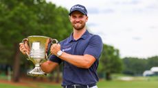 Wyndham Clark holds the trophy after his win at the Wells Fargo Championship