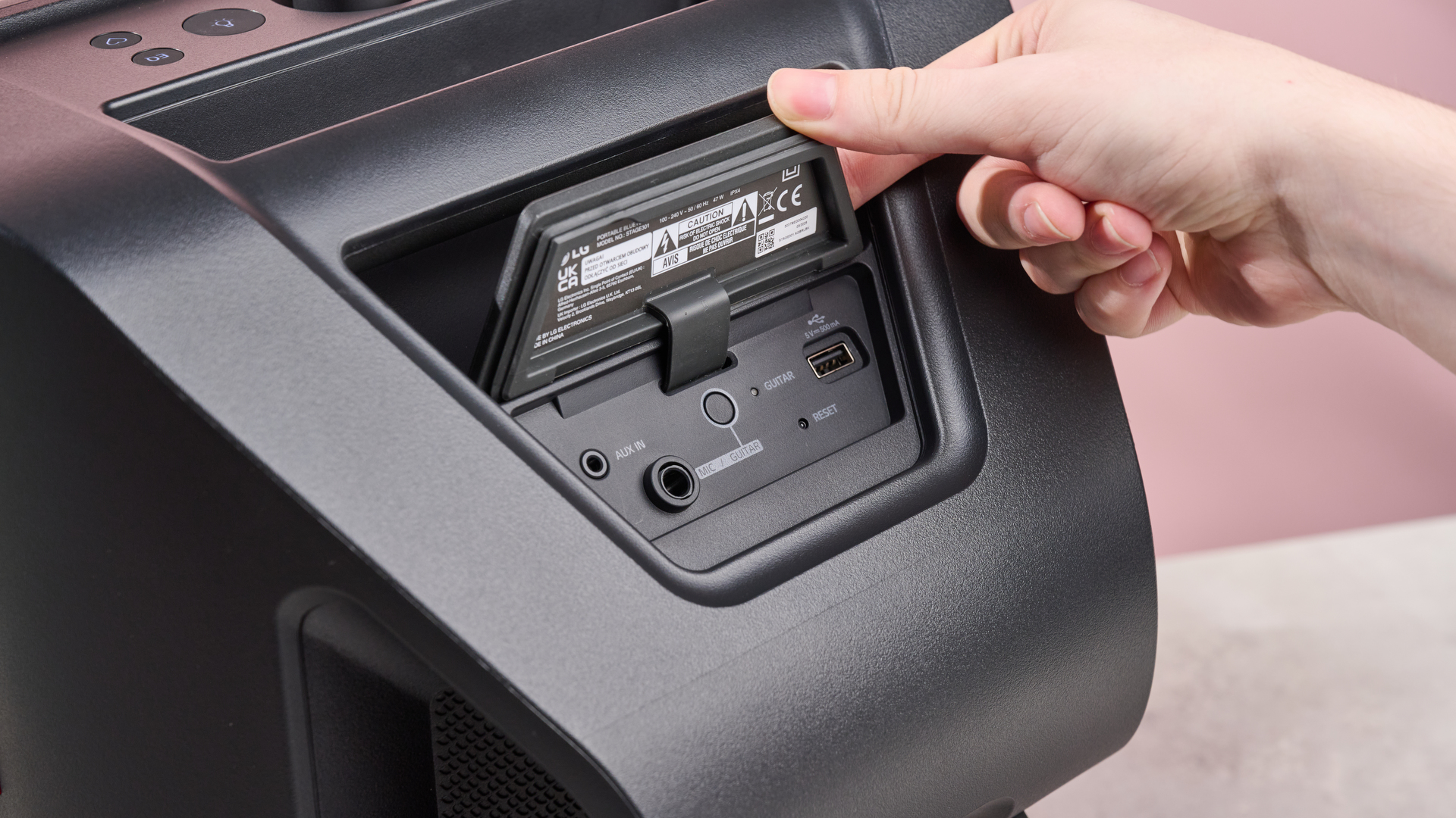 Person lifting tab on the reverse side of the LG xboom Stage 301