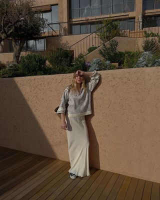 @camillecharriere wearing converse with a slip skirt and striped jumper
