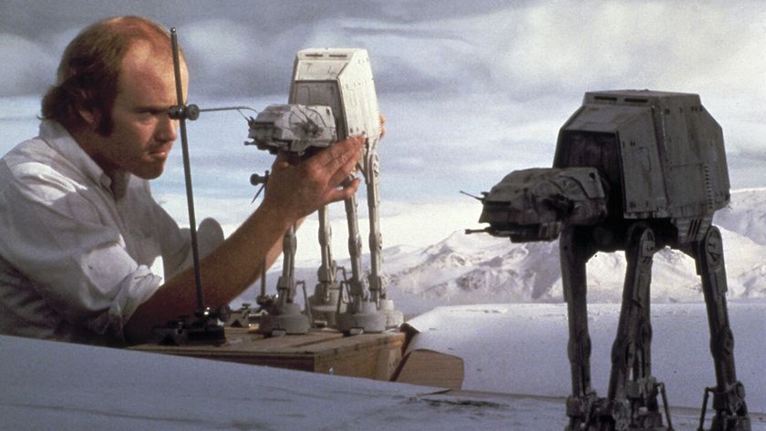 A man adjusts sci-fi miniatures on a snowy backdrop