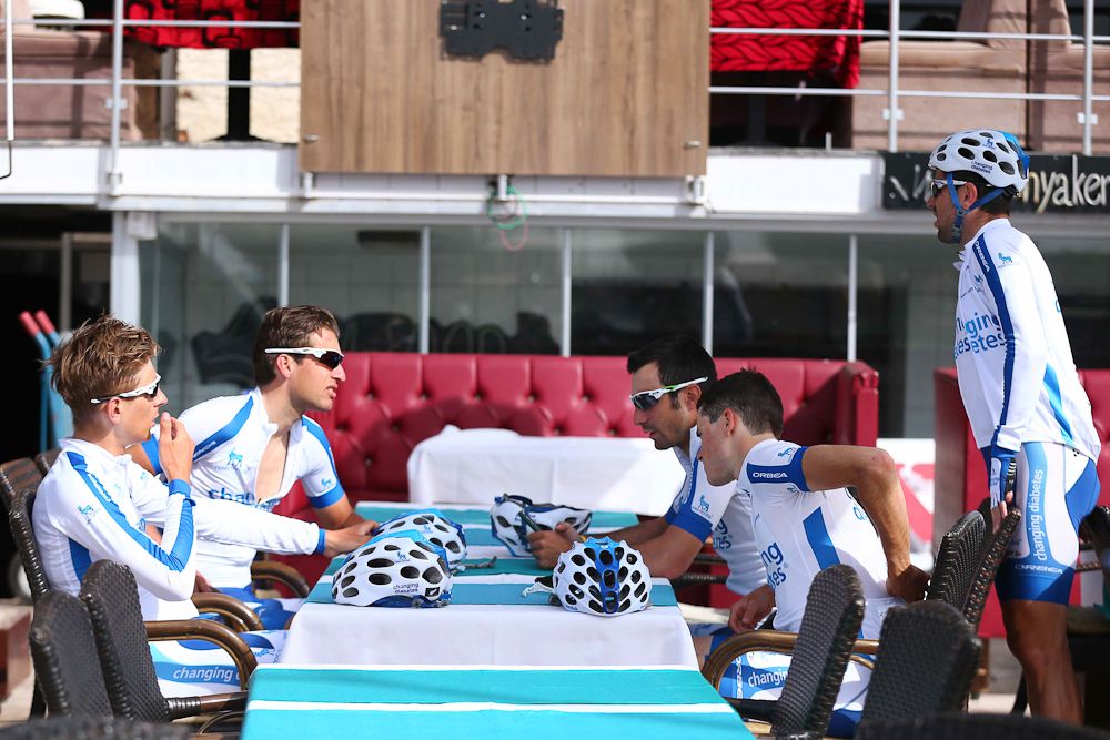Novo Nordisk riders relax before the start of stage 2.