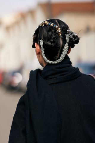 woman with silver hair accessories facing away from the camera