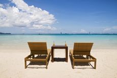 Beach chairs on white sand in Florida