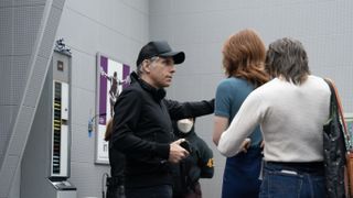 Ben Stiller in a black top and cap on the set of Severance.