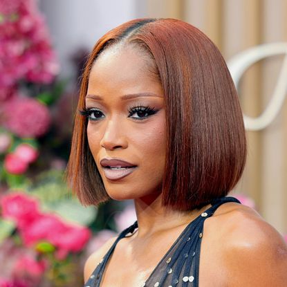 a black woman with red, bob-length hair