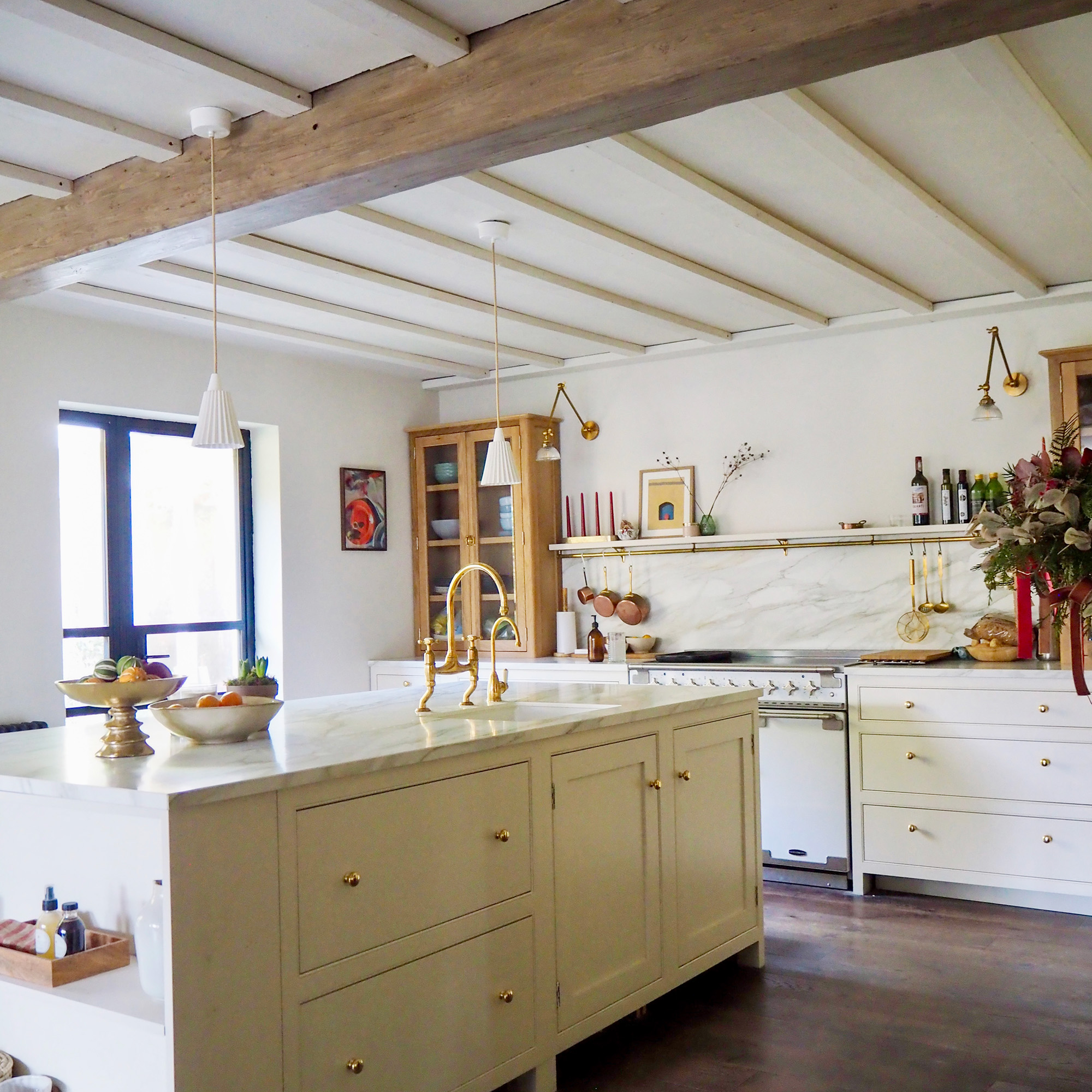 kitchen with neutral white walls and cabinetry and island with dark wood flooring and unpainted wooden unit cabinets