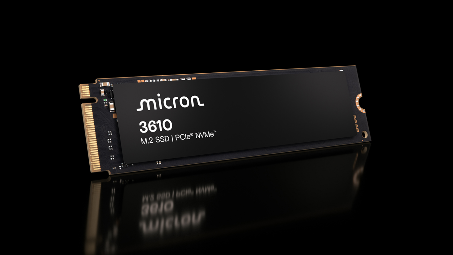 The Micron 3610 SSD rests on a reflective surface on a black background.