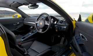 View through the open door of the car to the black leather interior