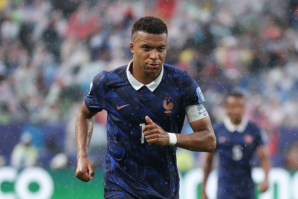 Kylian Mbappe is seen running off the pitch in heavy rain after the first half during the FIFA World Cup 2026 Group I match between France and Iraq at Philadelphia Stadium