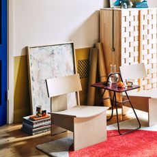 A room with two birch wood easy chairs from IKEA's PS 2026 collection and a folding table in burgundy from the same range