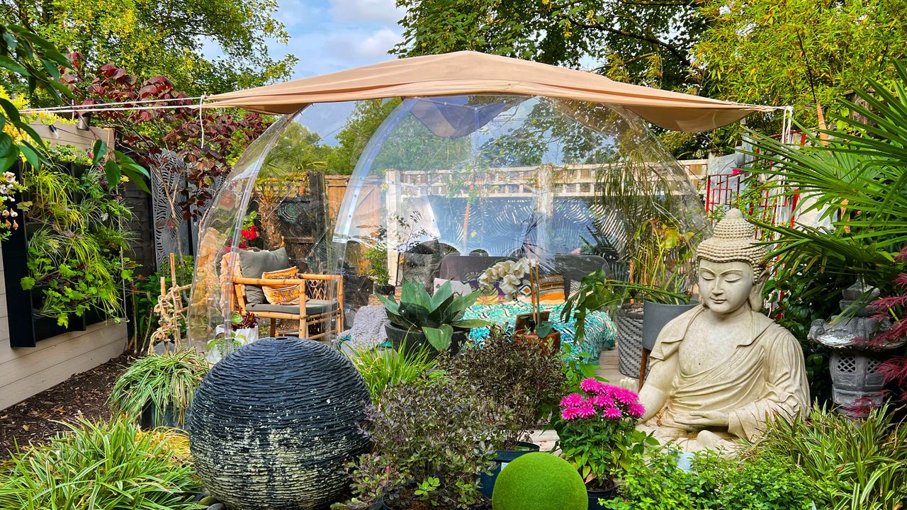 Garden with geodome made for outdoor living and plants around it.