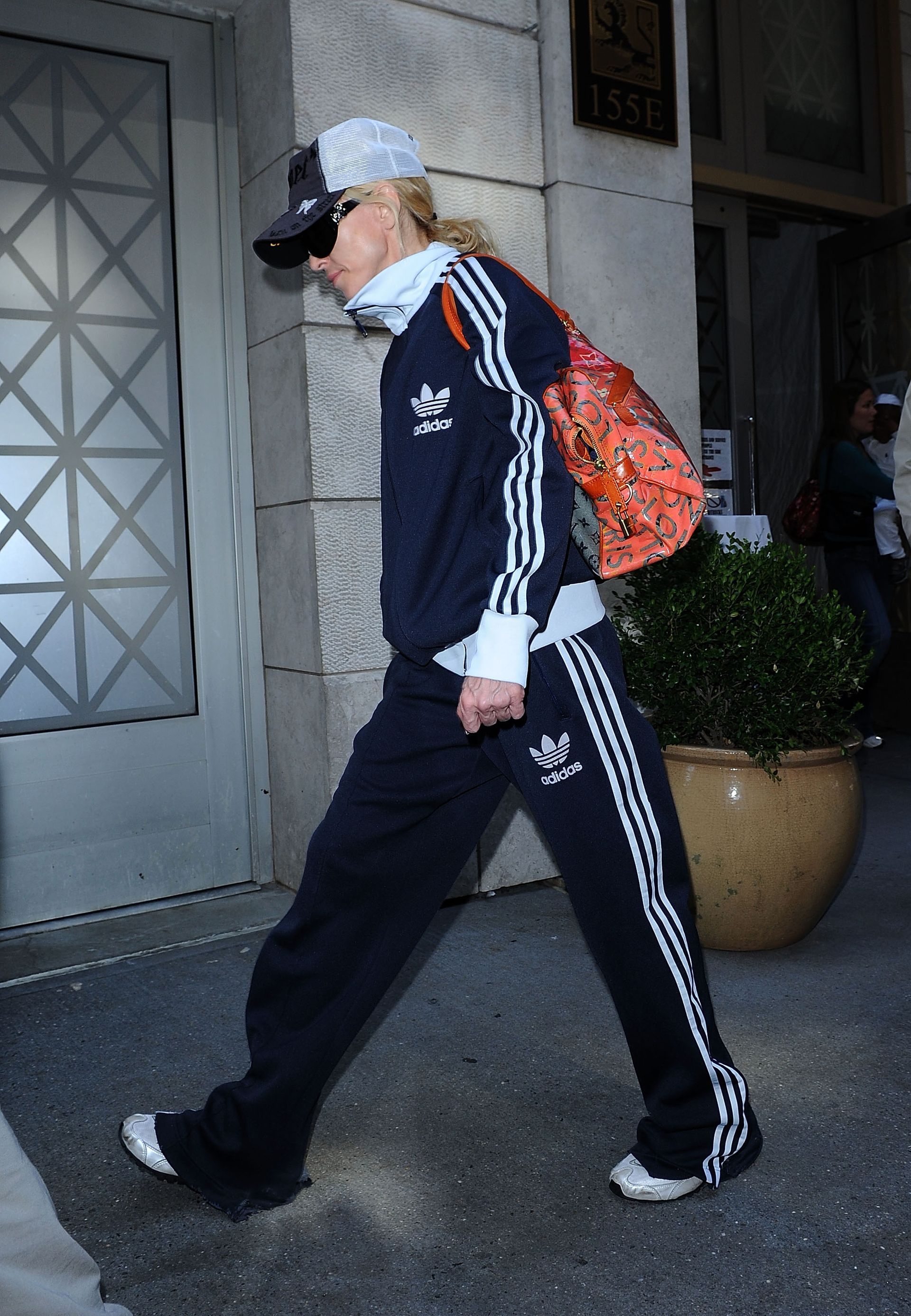 An image of Madonna wearing a matching Adidas tracksuit while out in New York in 2008.