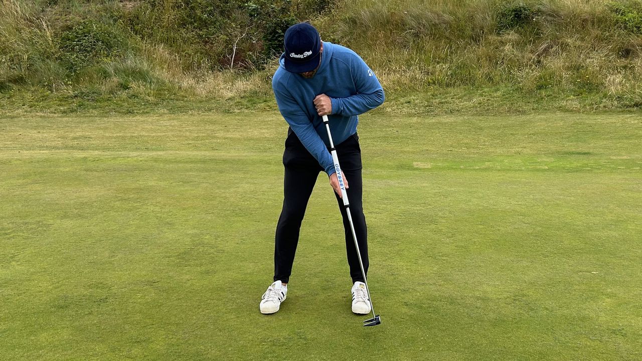 Photo of Joe Ferguson using a broomhandle putter