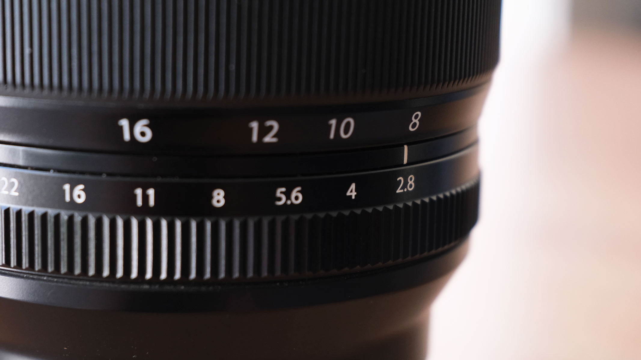 A close-up of the Fujifilm XF 8-16mm f/2.8 lens showing the widest aperture of f/2.8