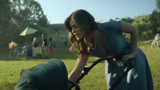 Grace leaning over to tend to a baby in a carriage in the park in The Umbrella Academy's series finale