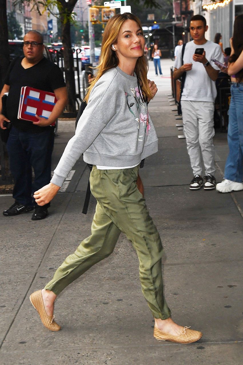 Michelle Monaghan wearing a gray sweatshirt, olive green pants, and tan woven flats in NYC