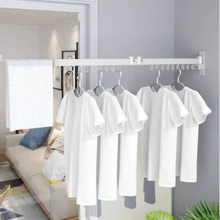 Pull out white rail with white T shirts in grey room