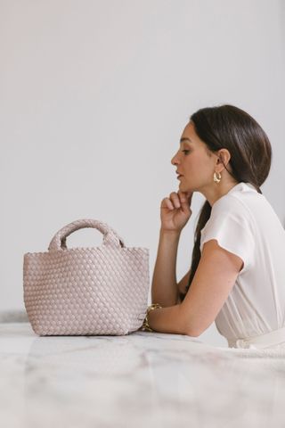 Handbag designer Sara Saghedi and one of her bags from the latest collection