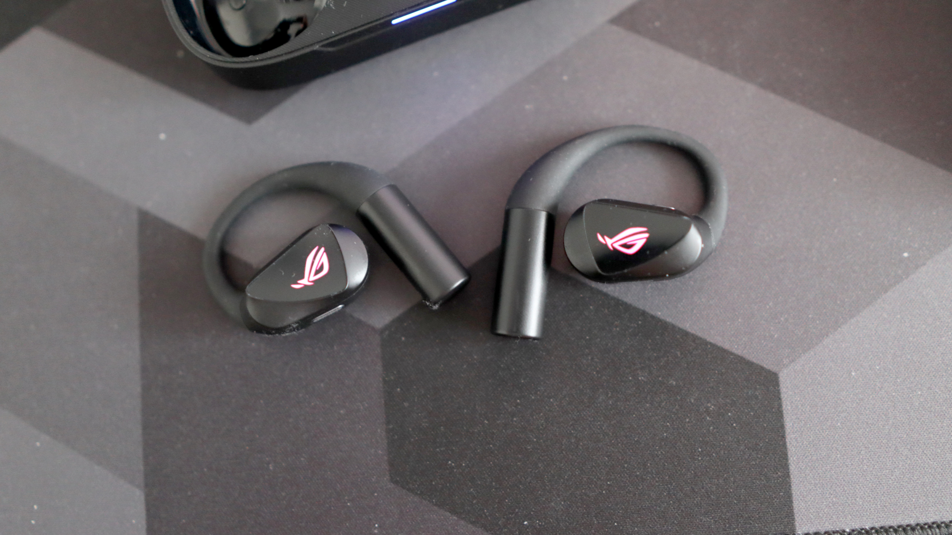 Asus ROG Cetra Open earbuds on a deskmat.
