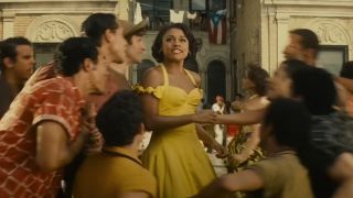 Ariana DeBose in a yellow dress singing about America in West Side Story