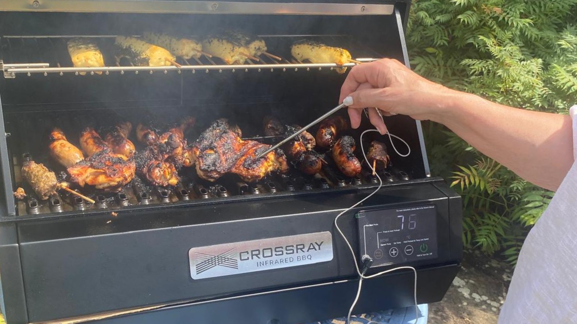 The Dimplex Crossray eXtreme Portable Electric BBQ being used to cook meat by our tester, Lesley